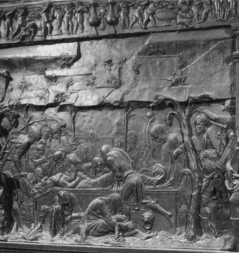 The Passion Pulpit relief showing a burial scene with robed figures beneath classical columns and a decorative frieze.