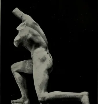 Incomplete Subiaco Ephebe sculpture of a kneeling male figure with broken arms on a rectangular base.
