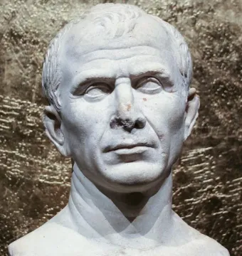 Weathered white marble bust of an older man with short wavy hair and a serious expression.