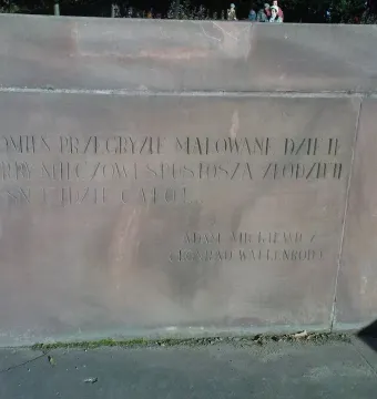 Close-up of the Chopin Monument base with an engraved Polish inscription.