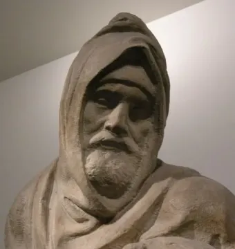 Detail of The Deposition showing a bearded hooded figure looking downward, with the top of another figure visible below.