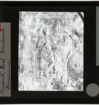 Monochrome slide of the Disc of Theodosius showing an enthroned figure holding an orb, flanked by two armed figures.