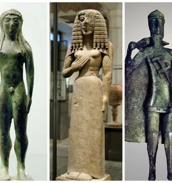 Three ancient statuettes: a nude green-patinated male figure, a robed figure with an elaborate wig, and a cloaked figure holding a staff.