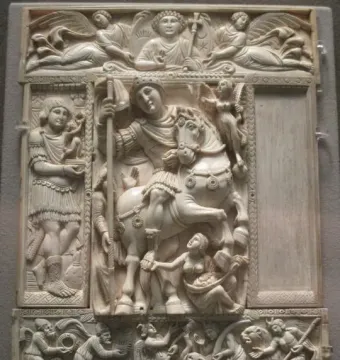 Barberini Ivory panel with a central relief of a mounted warrior holding a staff, surrounded by smaller carved figures and celestial scenes.