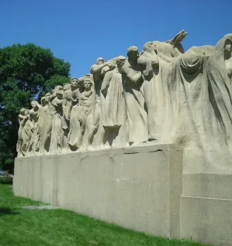 The Fountain of Time sculpture with many stone figures in a solemn procession.