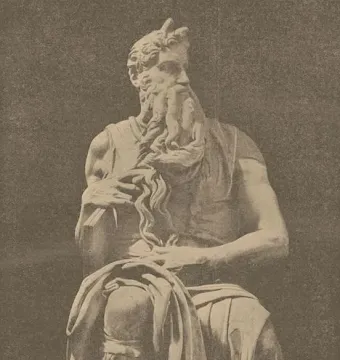 Seated statue of Moses with a long curly beard, horns, and tablets under his arm.