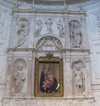 Piccolomini Altarpiece with a central painting of the Virgin Mary and Child, flanked by large marble statues and ornate sculpted panels.