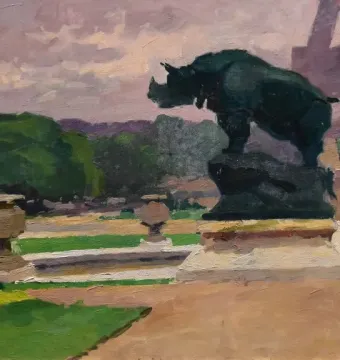 The Rhinoceros sculpture on a stone pedestal overlooking a park, with the Eiffel Tower faintly visible in the distance.