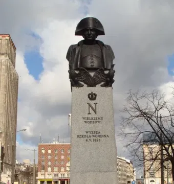 The Emperor Napoleon I Memorial bust on a stone plinth with crowned N and eagle reliefs in Warsaw.