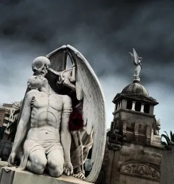 The Kiss of Death sculpture showing a winged skeleton leaning over a kneeling man and kissing his forehead.