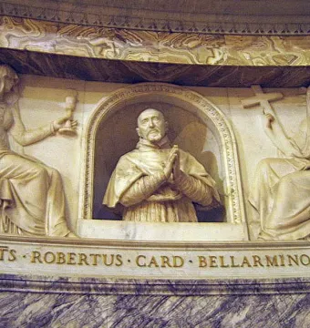 Marble relief monument of Cardinal Roberto Bellarmine in an arched niche, flanked by seated female figures holding a chalice, book, and crucifix.