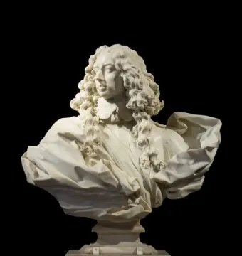 Marble bust of Francesco I d\'Este with curly hair, ornate collar, and draped clothing on a pedestal.
