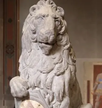 Marzocco stone lion with its paw resting on a shield bearing a fleur-de-lis.