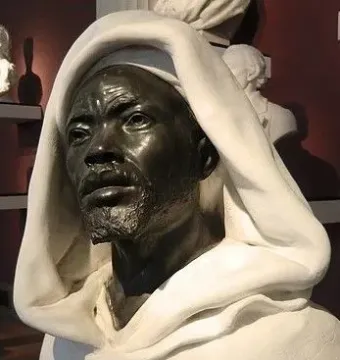 Salem, Negro of Sudan sculpture showing a man’s head and shoulders with a draped white hood.