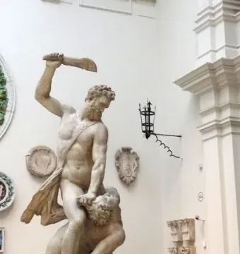 Samson Slaying a Philistine marble sculpture in a museum gallery, with one figure standing over another and raising a club.
