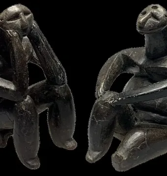 The Thinker of Cernavodă seated in a thoughtful pose beside the Sitting Woman of Cernavodă.