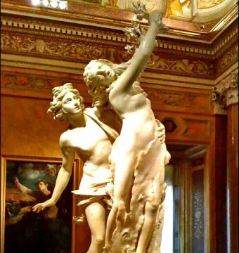 Apollo and Daphne marble sculpture showing two figures in a dramatic pose, with Daphne transforming into a laurel tree.