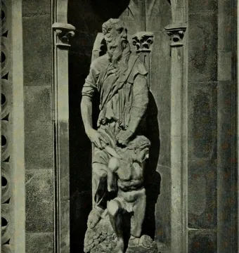 Stone relief of Abraham and Isaac, showing an older bearded man standing over a crouching, seminude younger figure in a carved niche.