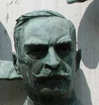 Polio Hall of Fame sculpture of Karl Landsteiner with a weathered bronze head and shoulders, showing a handlebar mustache and deep-set eyes.