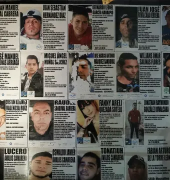 Wall covered with missing person posters at The Roundabout of the Disappeared.
