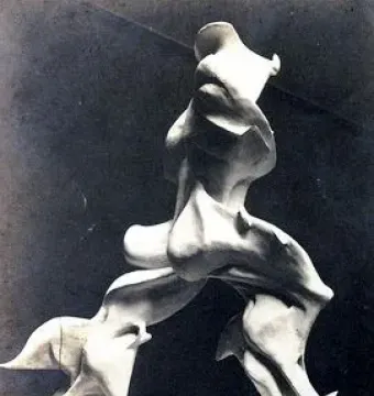 Unique Forms of Continuity in Space, a light-colored abstract sculpture in dynamic forward motion