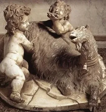 The Goat Amalthea marble sculpture showing a shaggy goat with two small child-like figures beside it.