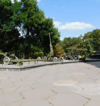 Battle of the Dnieper Diorama with a tank, rocket launcher, and artillery pieces displayed outdoors.