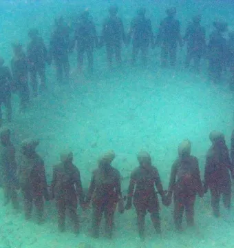 The Molinere Underwater Sculpture Park’s ring of human-like figures standing hand in hand on the seabed.