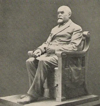 Timothy Eaton statue showing a seated bearded man in a double-breasted suit on a rectangular base.