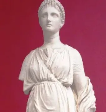 Artemis Diadoumena marble statue of a standing female figure with draped robes, braided hair, and a missing right arm below the shoulder.
