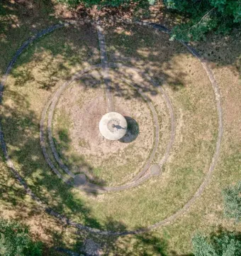 Aerial view of the UFO Memorial showing a circular ground design with a central pedestal and concentric rings.