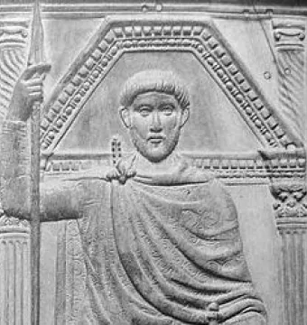 Carved detail from the Diptych of Stilicho showing a bearded man in a patterned cloak holding a spear between architectural columns.