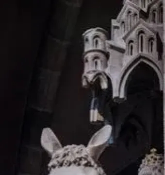 The Bamberg Horseman statue shown against a dark Gothic archway.