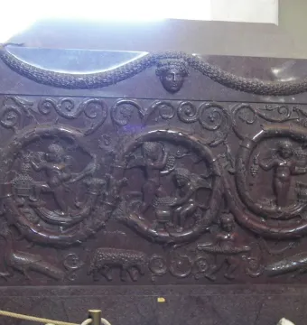Sarcophagus of Constantina with carved reliefs of winged putti, foliage, garlands, and animal figures.
