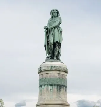 The Vercingetorix Monument, a green-patinated bronze warrior statue on a tall stone pedestal.