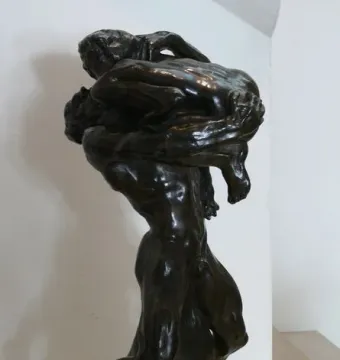 I Am Beautiful bronze sculpture of two intertwined nude figures with a French inscription on the base.