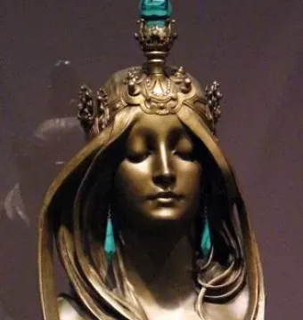 Nature bronze bust of a serene woman with closed eyes, flowing hair, and a jeweled crown.