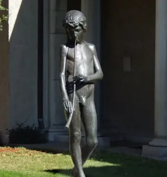 Spirit of Spanish Music bronze sculpture of a barefoot boy playing a long wind instrument on a fountain base