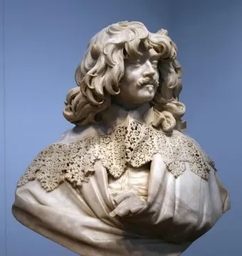 Marble bust of Thomas Baker with long wavy hair, a mustache, and an ornate lace collar.