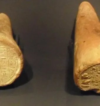 Two ancient Egyptian funerary cones with pressed hieroglyphic inscriptions on the flat ends.
