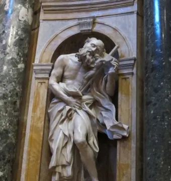 Saint Jerome sculpture by Gian Lorenzo Bernini, showing a bearded figure in flowing robes holding a cross and standing with one foot on a lion\'s head.