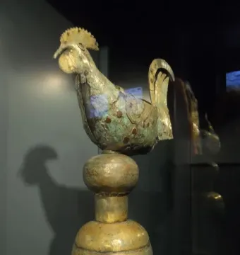 Gallo di Ramperto rooster weather vane with a weathered metallic finish and green patina.