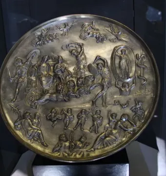 The Parabiago Plate, a large circular silver relief showing a deity riding a chariot pulled by lions, surrounded by figures and celestial motifs.