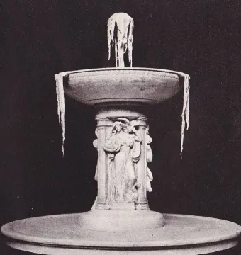 Tiered stone Dupont Circle Fountain with an intricately carved central column and icicles hanging from the upper bowl.