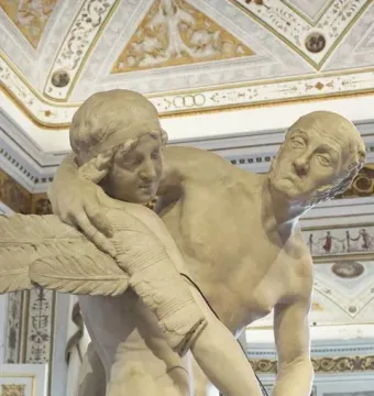 Daedalus and Icarus marble sculpture detail showing an older man embracing a younger figure with feathered wings.