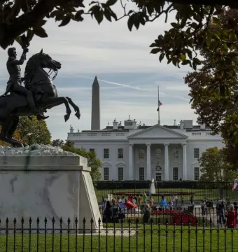 Andrew Jackson Statue on a tall stone pedestal with the White House and Washington Monument in the background