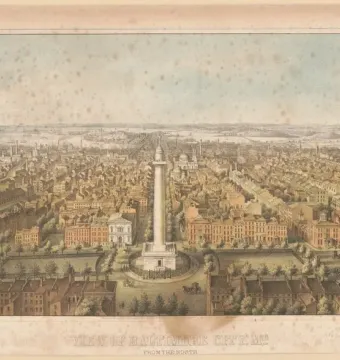 The Washington Monument rises above a Baltimore cityscape, surrounded by streets and buildings with water and hills in the distance.