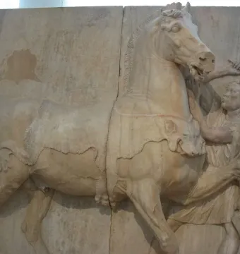 Attic funerary relief showing a horse with ornate covering and a young groom holding its lead beside it.