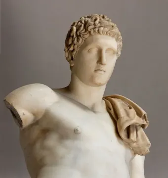 Hermes Belvedere marble sculpture with curly hair, a draped shoulder cloth, and a broken left arm.