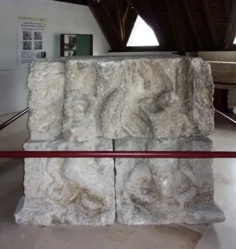 Stone relief blocks from the Pilier d\'Yzeures-sur-Creuse displayed in a museum setting.